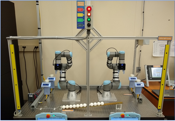 Photo of the Collaborative Robotics System work cell which includes 2 robotic arms.