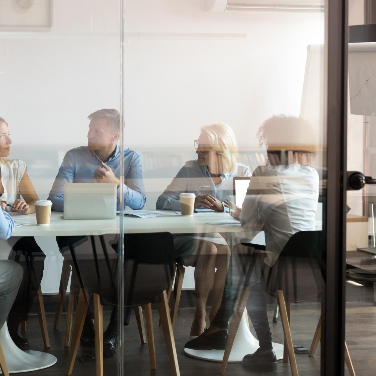 Group of business people meeting inside modern office space