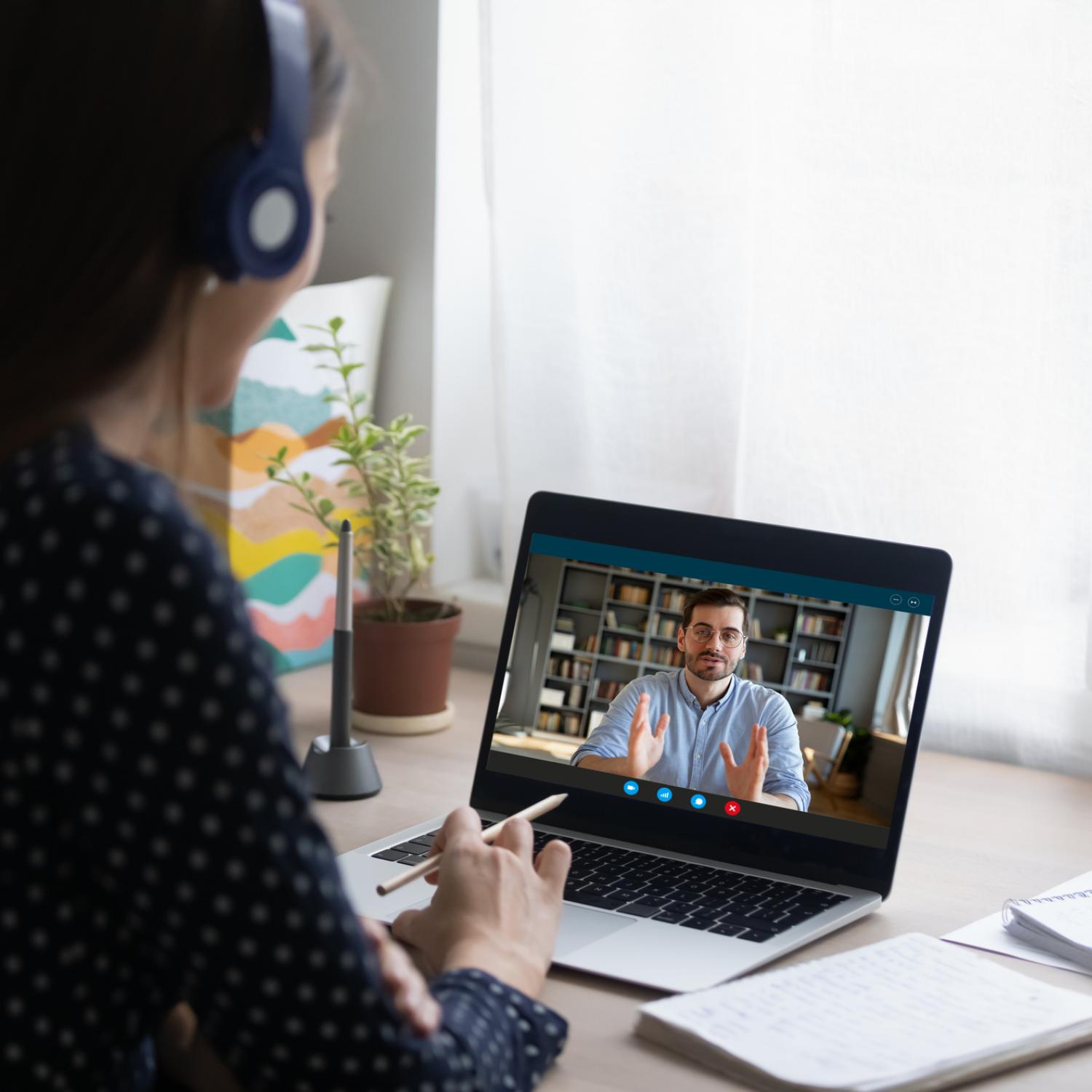 Person in  in headphones looking at computer screen