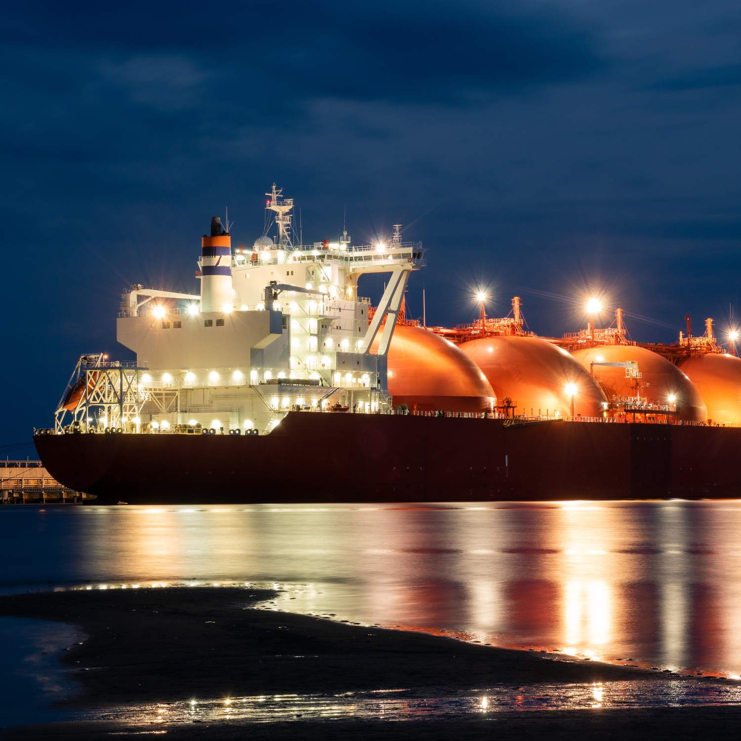 A photo of a liquefied natural gas transport tanker at night.