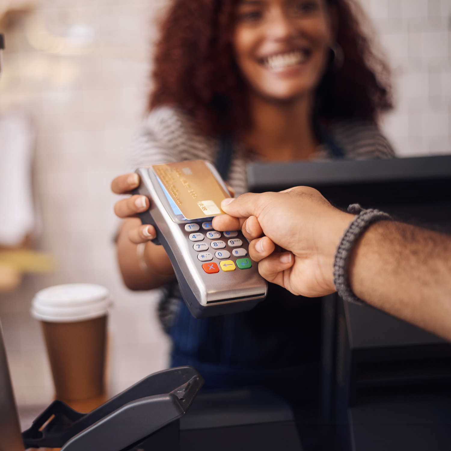 Closeup shot of a customer making a credit card payment in a cafe