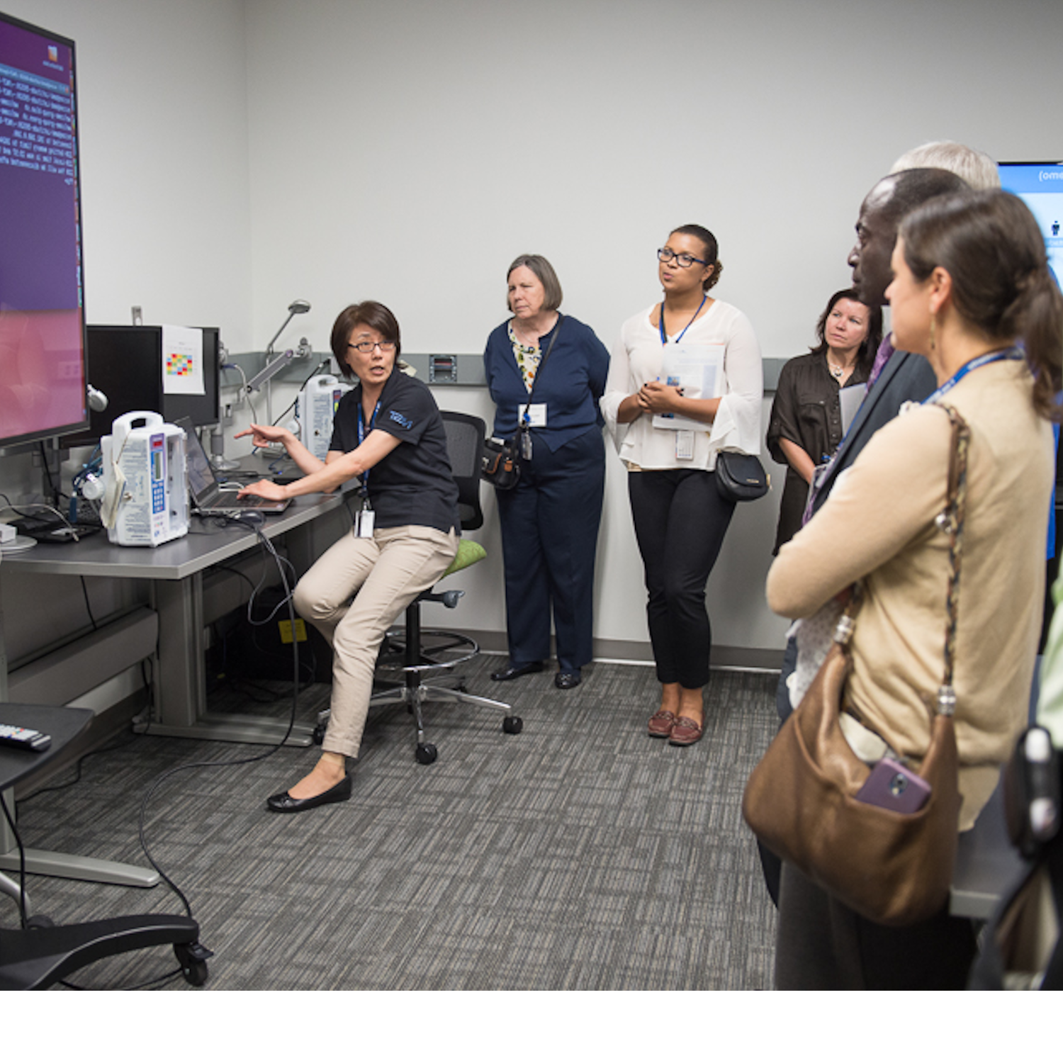 A photo of an NCCoE engineer giving a demonstration in the Healthcare lab.