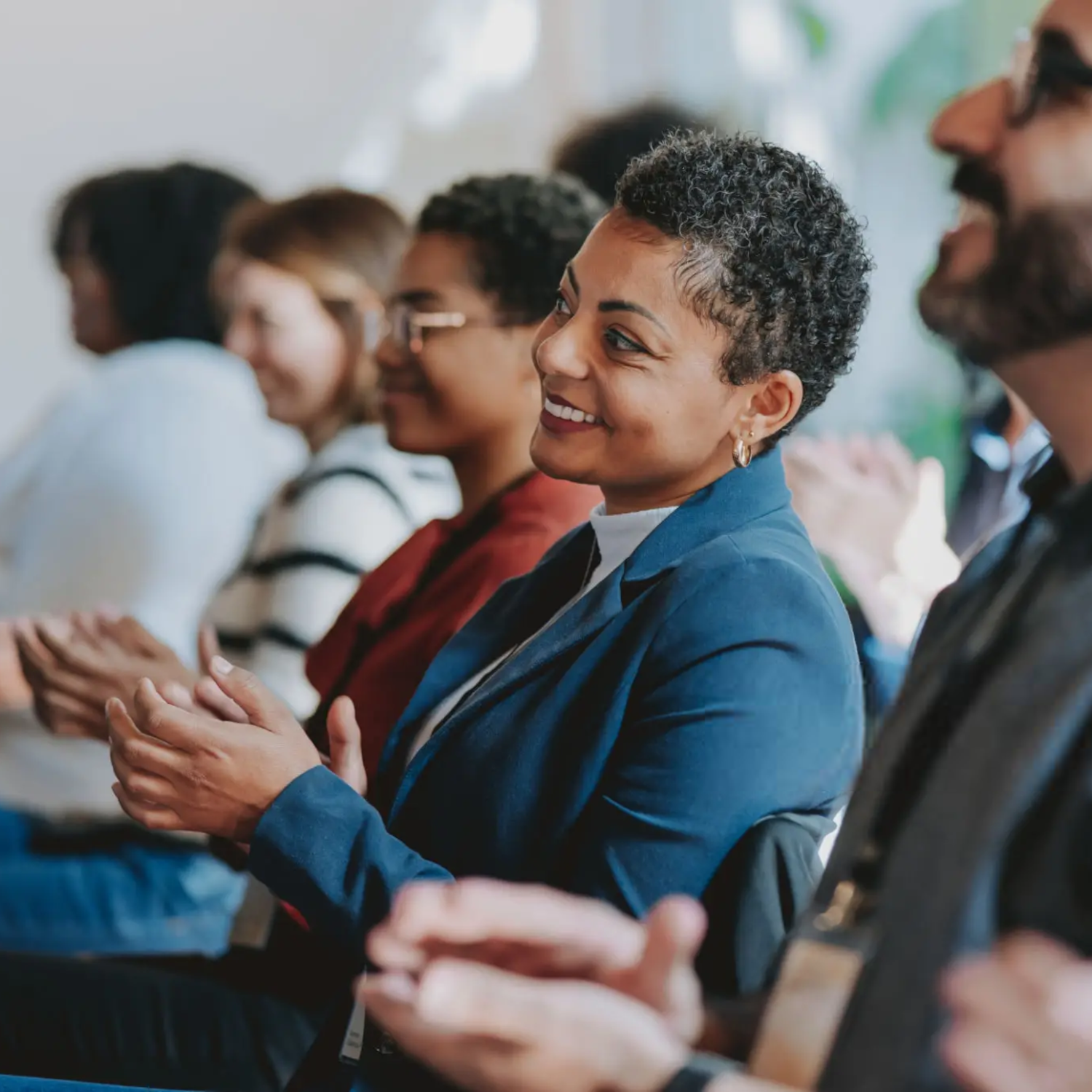 People clapping during a presentation.
