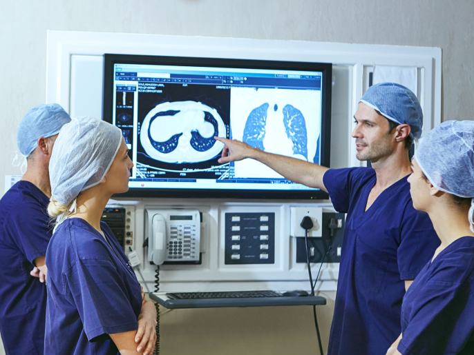 A photograph of medical professionals viewing x-rays.