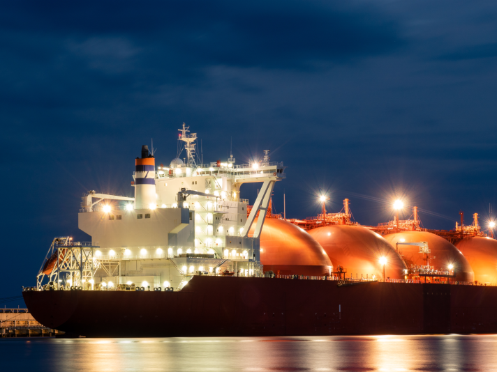 A photo of a liquefied natural gas transport tanker at night.