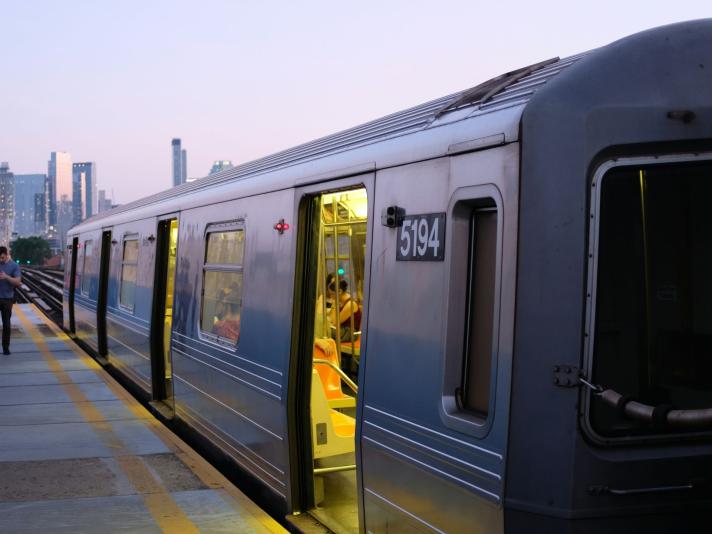 Train with a city skyline.