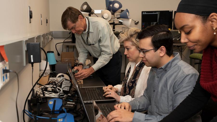 Group of NCCoE engineers working in lab