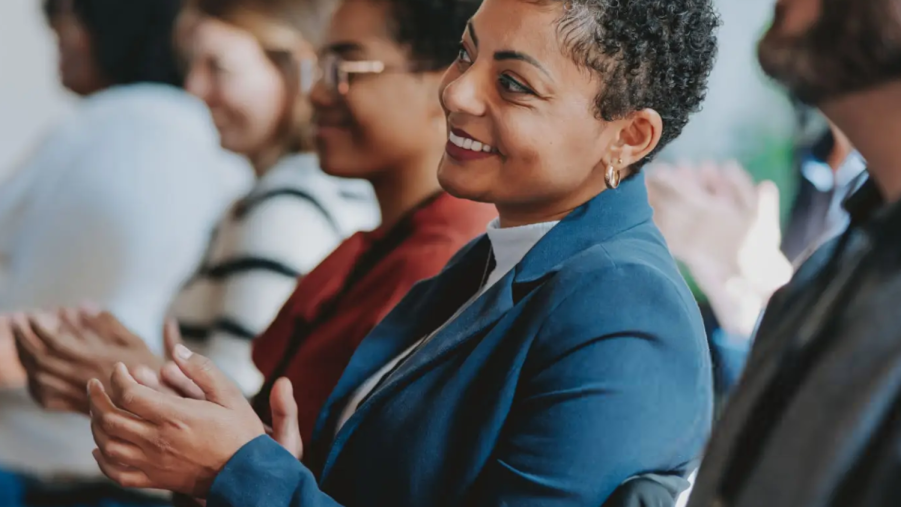 People clapping during a presentation.
